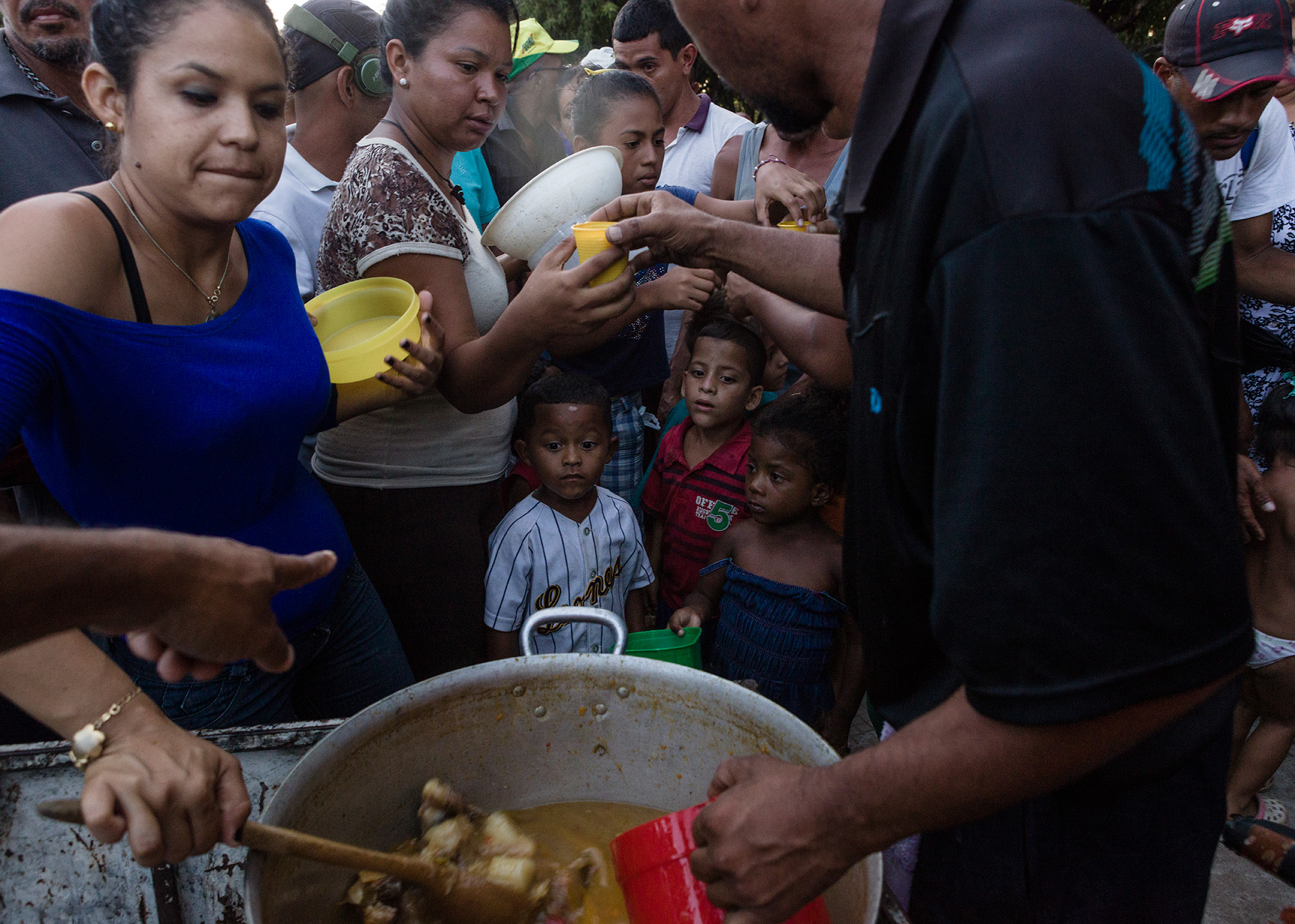 A boy starves while waiting to be feed at Simon Bolivar square, 2018.