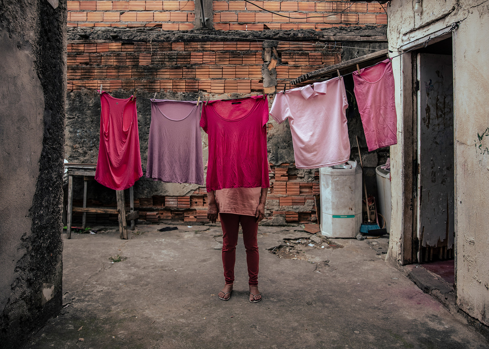 Isabel hanging her family women's pink t-shirts used to visit the imprisoned sons.